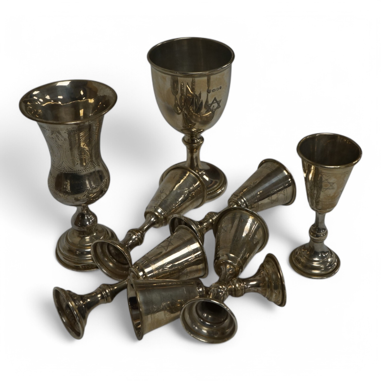 A set of six George V silver kiddush cups, maker MS?, London, 1924, 95mm, together with one other larger earlier silver kiddush cup and a 1960's silver goblet. Condition - poor to fair